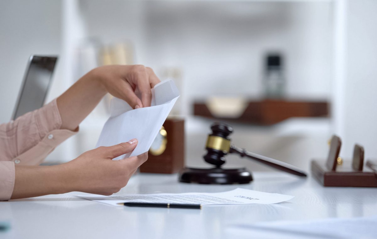 Divorced woman holding envelope with alimony, savings for single mom, allowance