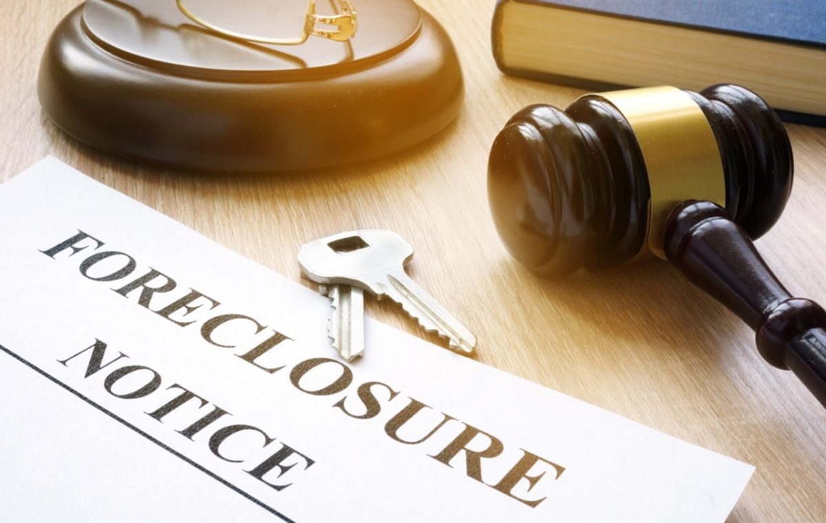 Foreclosure notice and keys on a court table.